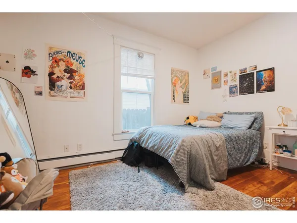 a spacious bedroom with a bed and a window