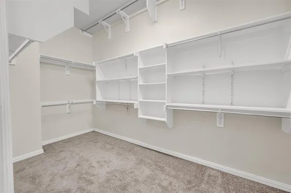 a view of an empty room with a ceiling fan