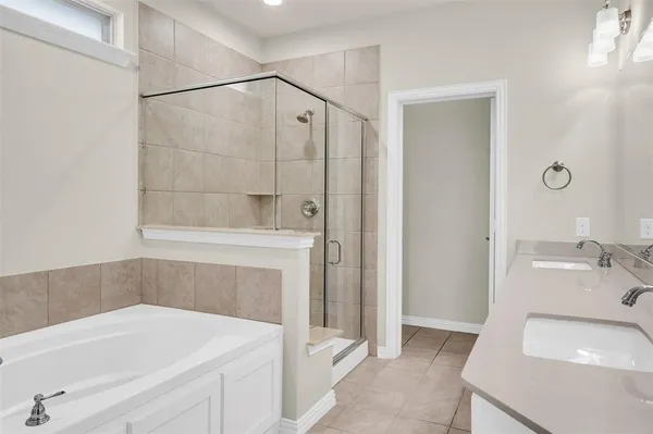a bathroom with a bath tub and shower