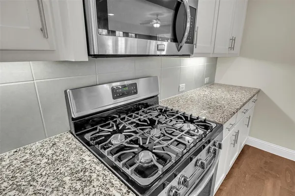 a kitchen with a stove and a microwave