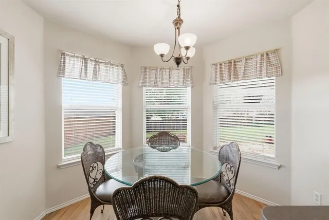 a view of a dining room with furniture and windows