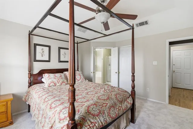 a bedroom with a bed and a mirror