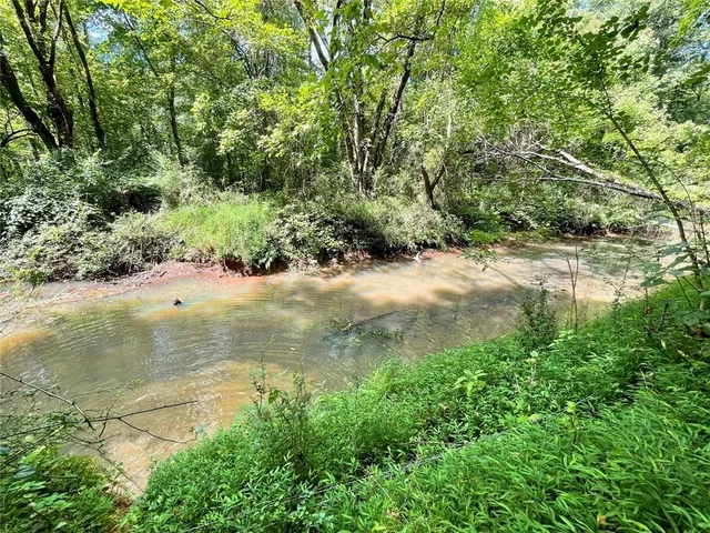 a view of white house with a yard