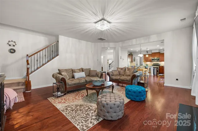 a living room with furniture and a chandelier