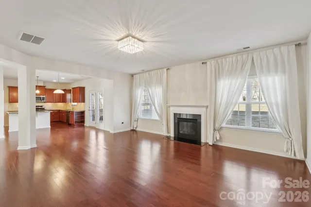 a view of a yard with wooden fence
