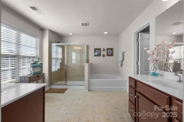 a spacious bathroom with a shower tub and sink