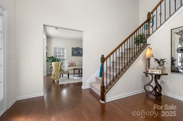 a view of entryway and hall with wooden floor