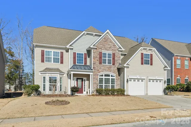 front view of a brick house with a large windows
