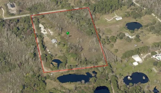 an aerial view of residential house with outdoor space
