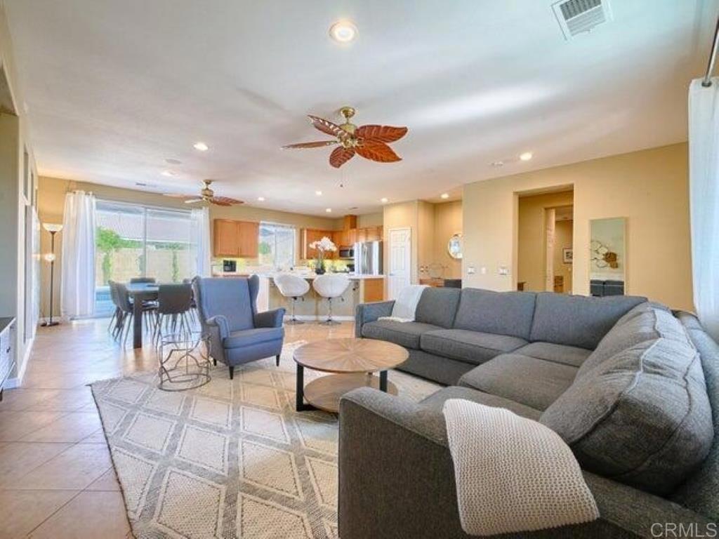 80596 Key Largo Avenue Indio, CA 92201 - Photo 5 of 59 a living room with furniture kitchen view and a chandelier