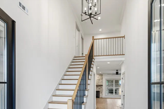 an empty room with a ceiling fan and carpet