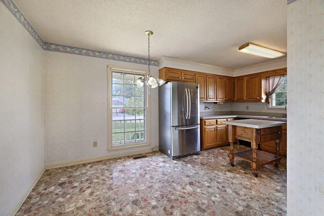 a kitchen with refrigerator cabinets and wooden floor