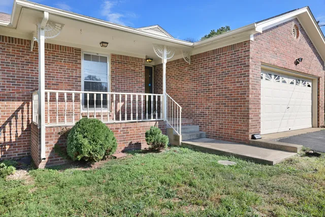 a view of a house with a yard and plants