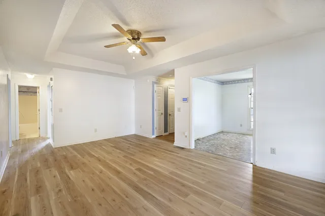 a view of an empty room and wooden floor