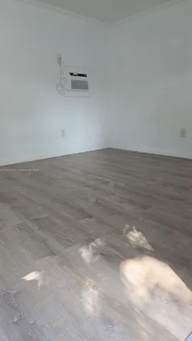 a view of a room and wooden floor