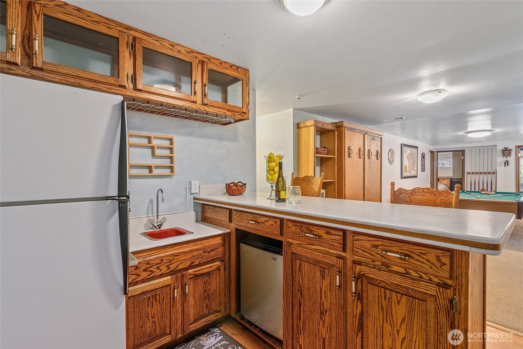 18009 Bellflower Road Bothell, WA 98012 - Photo 29 of 40 a kitchen with stainless steel appliances granite countertop a refrigerator a stove and a sink with cabinets