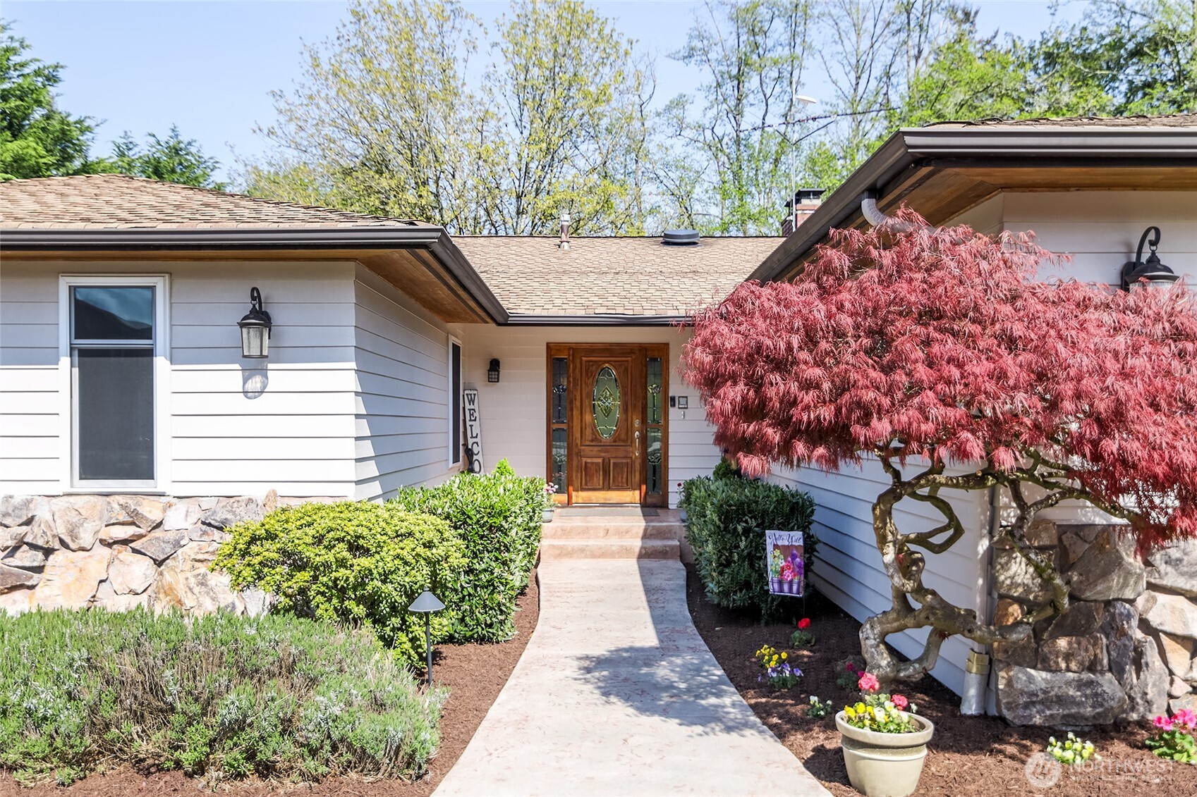 18009 Bellflower Road Bothell, WA 98012 - Photo 3 of 40 a front view of a house with a yard and fountain