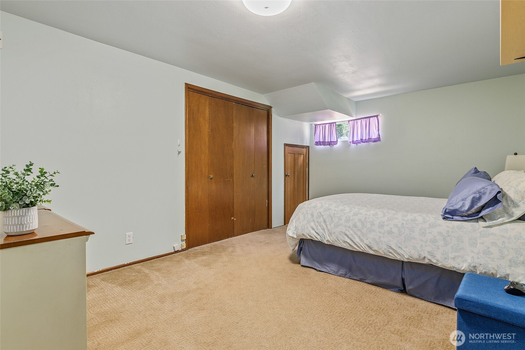 18009 Bellflower Road Bothell, WA 98012 - Photo 33 of 40 a bedroom with a bed and a potted plant