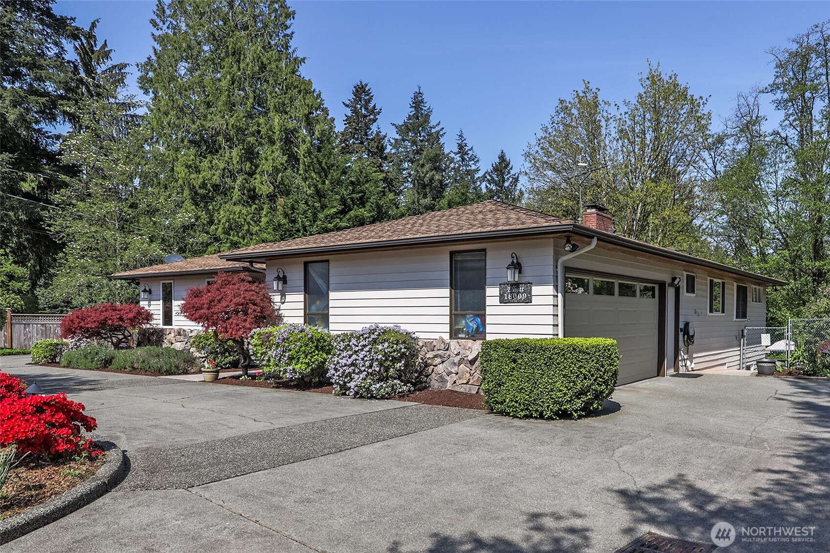 18009 Bellflower Road Bothell, WA 98012 - Photo 38 of 40 a front view of a house with a yard and a garage