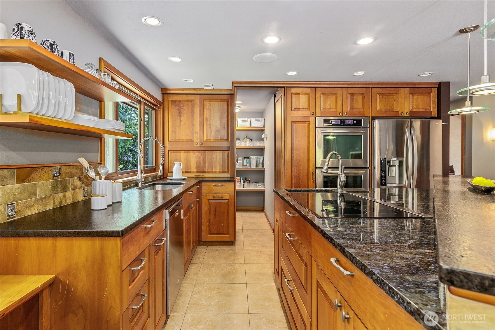 18009 Bellflower Road Bothell, WA 98012 - Photo 4 of 40 a kitchen with stainless steel appliances granite countertop a sink and counter space