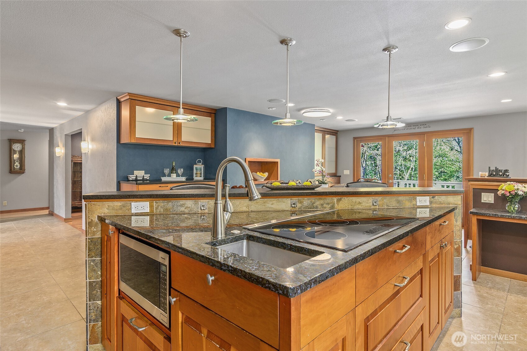 18009 Bellflower Road Bothell, WA 98012 - Photo 5 of 40 a kitchen with stainless steel appliances granite countertop a sink a counter space and a view of living room