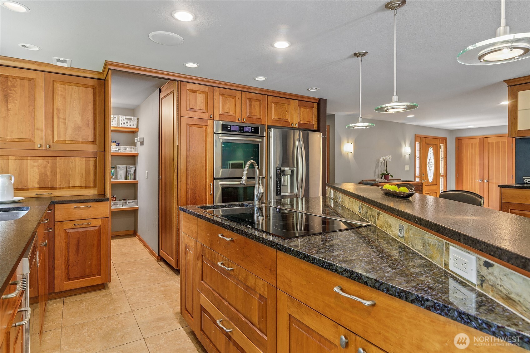 18009 Bellflower Road Bothell, WA 98012 - Photo 6 of 40 a large kitchen with kitchen island granite countertop a large counter top and wooden floors