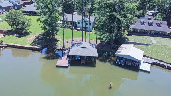 an aerial view of a house with swimming pool patio and outdoor seating
