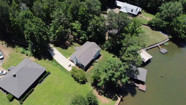 an aerial view of a house with garden space and street view