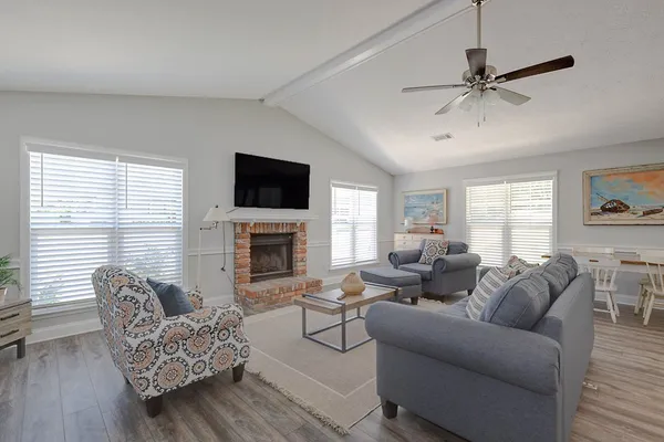 a living room with furniture a fireplace and a window
