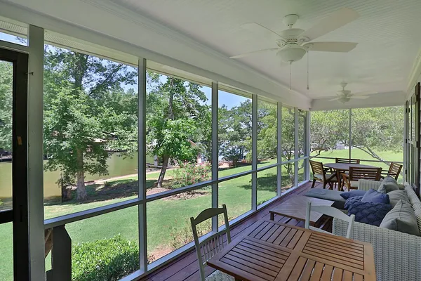 a living room with large windows and furniture