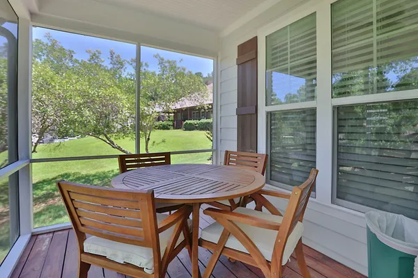 a view of a wooden table and chairs in patio