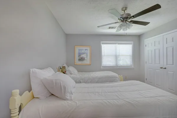 a bedroom with a large bed and a window