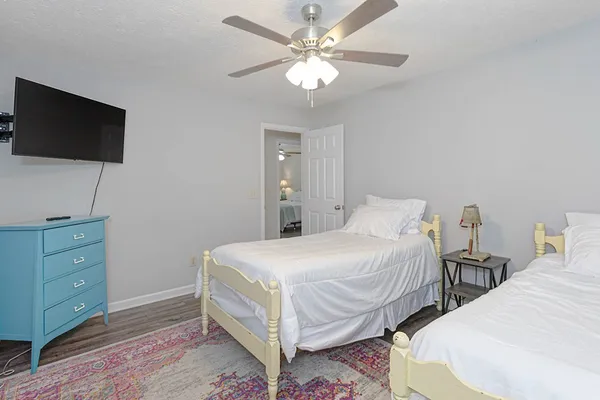 a bedroom with a bed and a flat screen tv