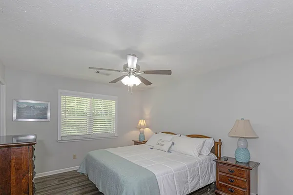 a bedroom with a bed and a table lamp