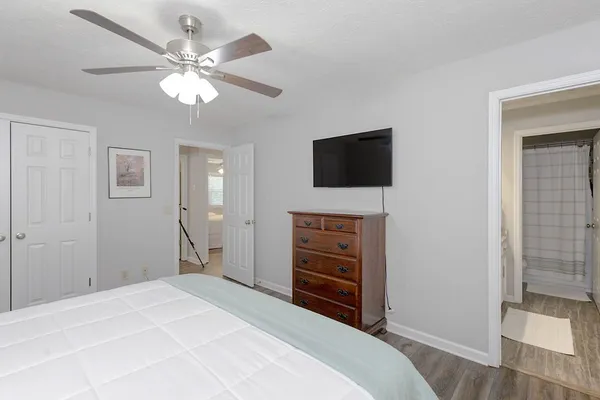 a bedroom with a bed and a flat screen tv