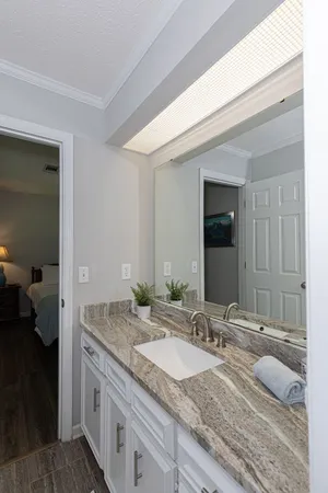 a bathroom with a granite countertop sink and a mirror