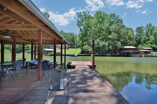 a view of a swimming pool with lawn chairs under an umbrella