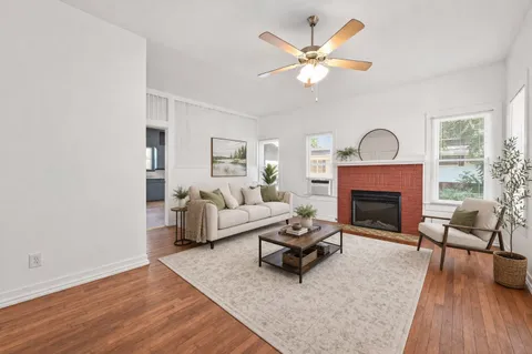 a living room with furniture and a fireplace