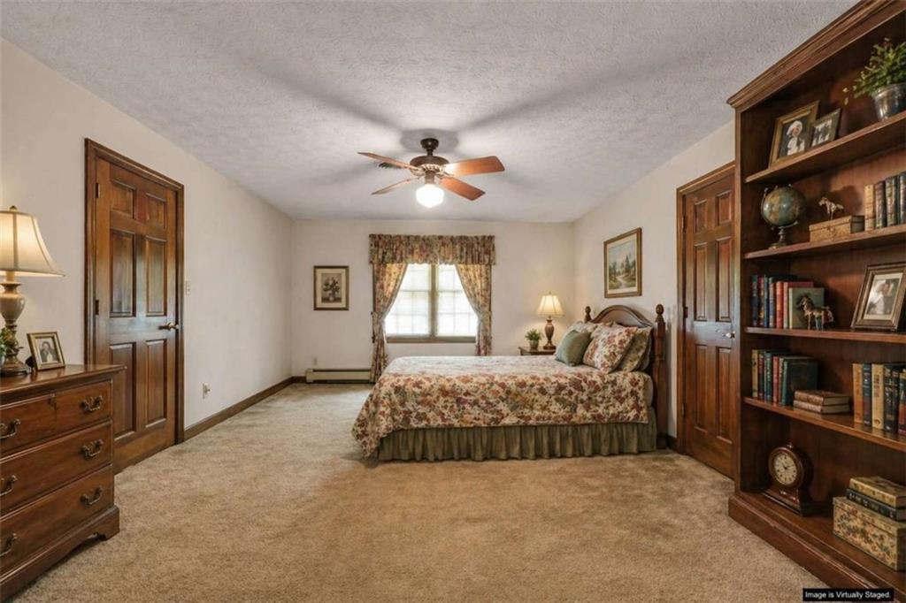314 Winding Stream Trail Southwest Conyers, GA 30094 - Photo 46 of 59 a spacious bedroom with a bed a dresser and book shelf