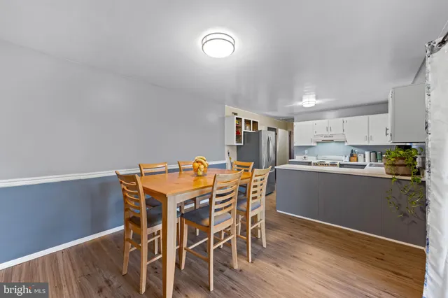 a view of a dining room with furniture and wooden floor
