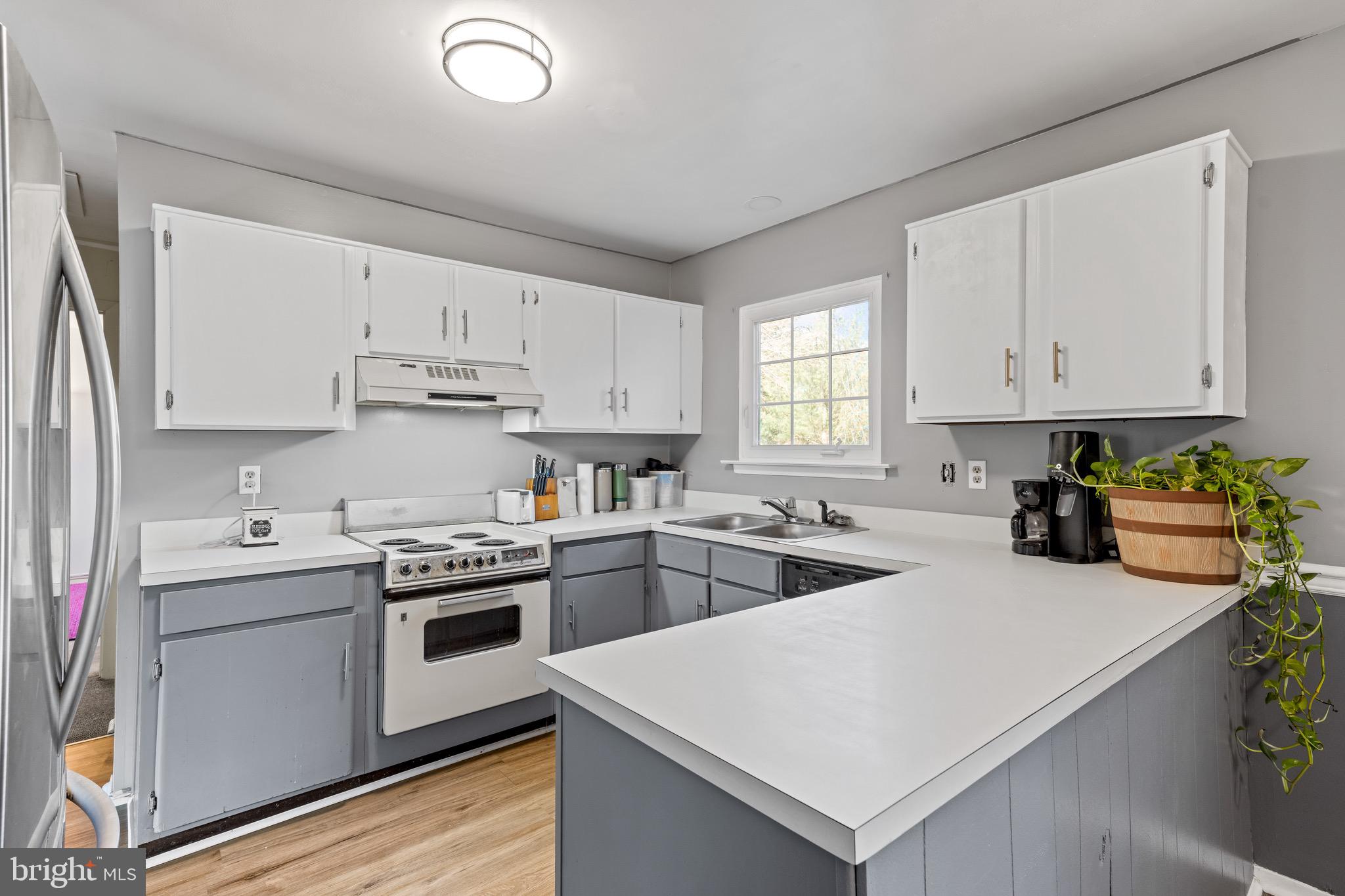 284 Radix Road Williamstown, NJ 08094 - Photo 9 of 30 a kitchen with cabinets appliances a sink and a window