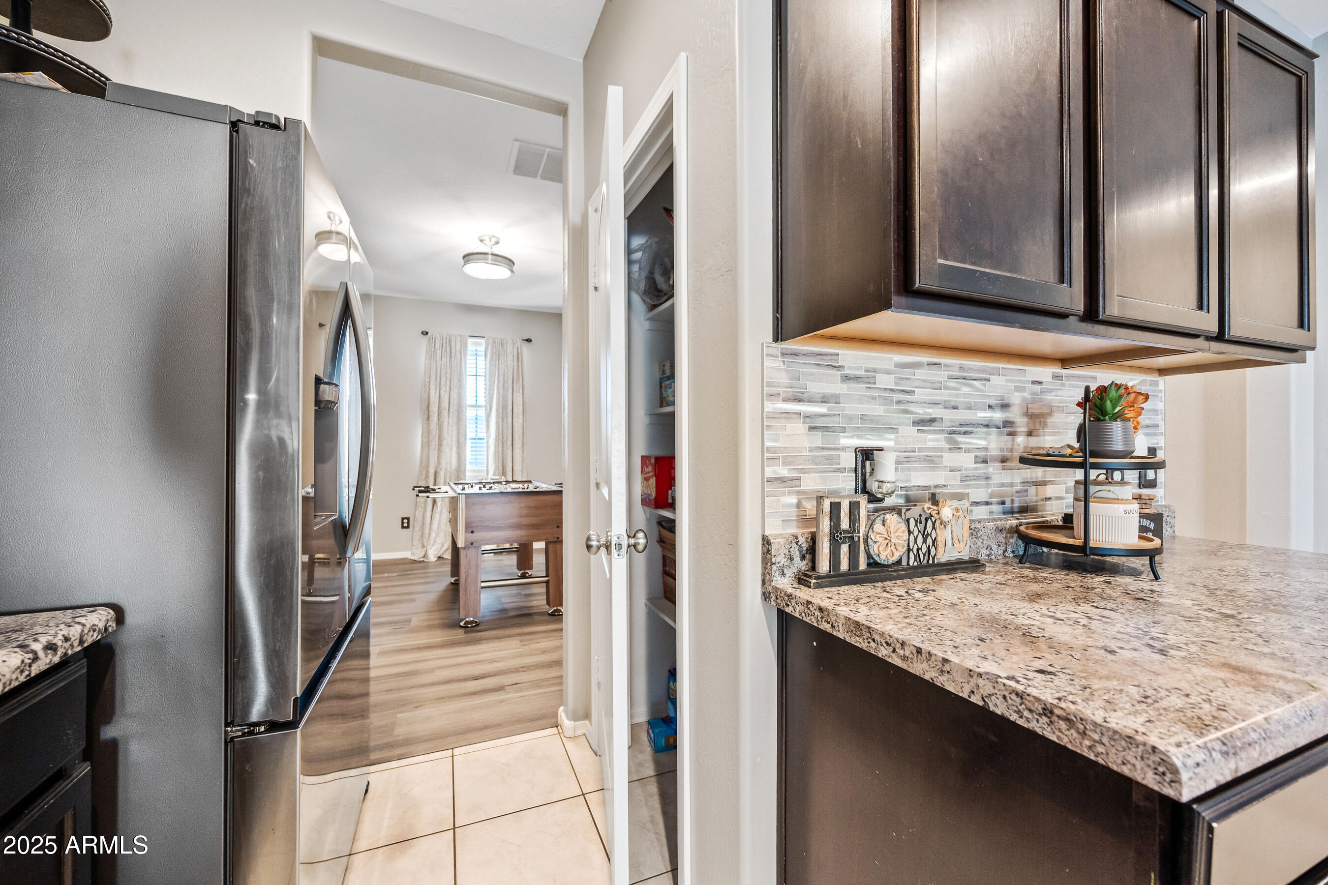25626 West Coles Road Buckeye, AZ 85326 - Photo 13 of 31 a kitchen with refrigerator and table
