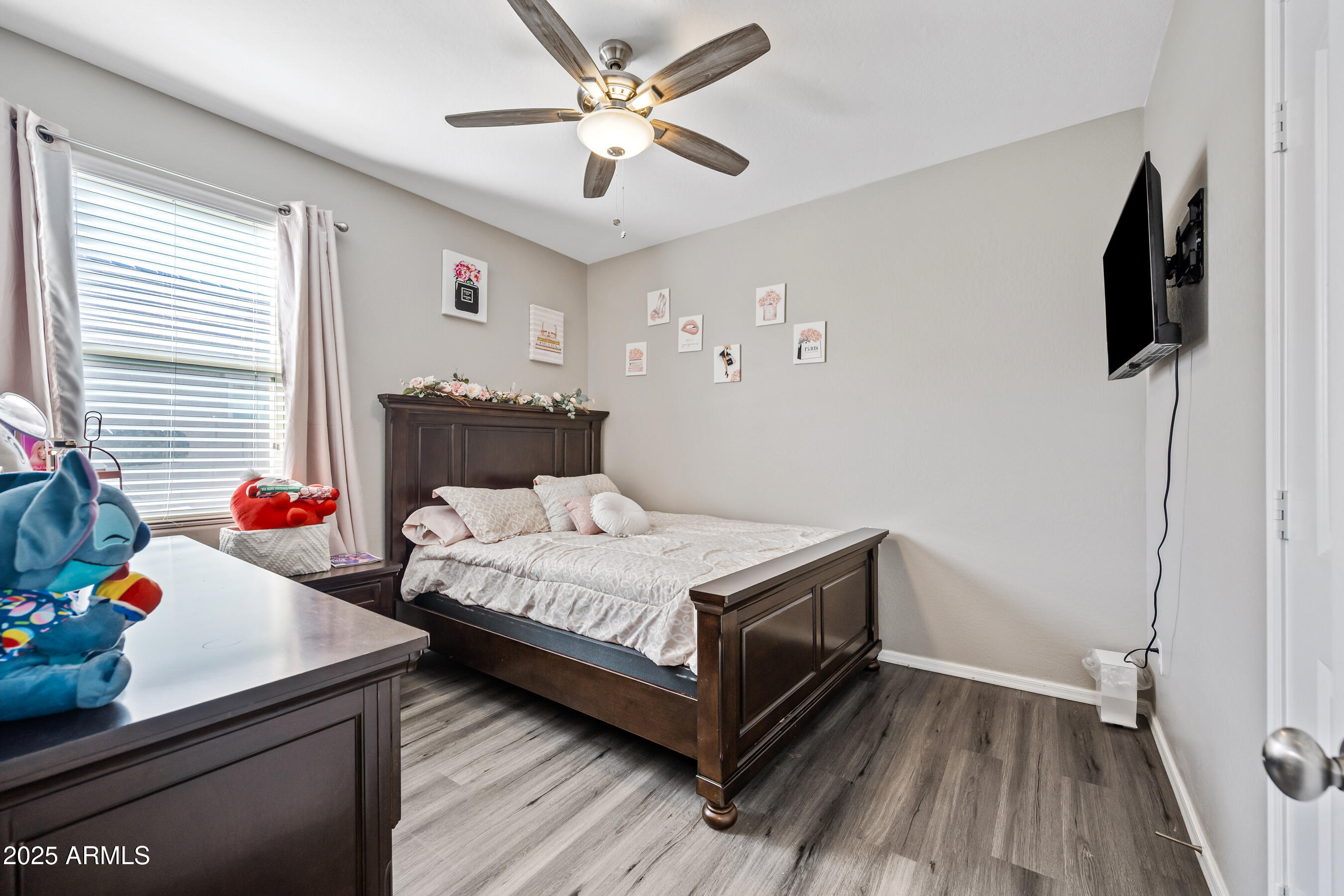 25626 West Coles Road Buckeye, AZ 85326 - Photo 24 of 31 a bedroom with a bed and a chandelier