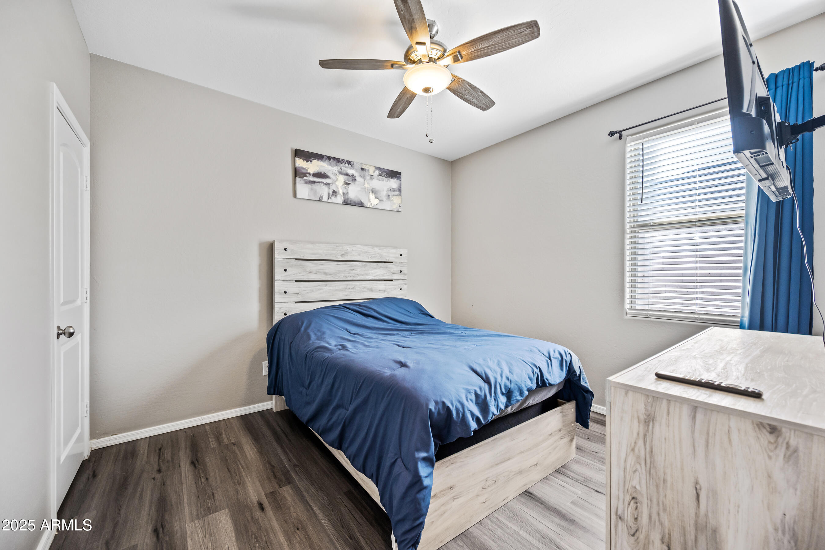 25626 West Coles Road Buckeye, AZ 85326 - Photo 25 of 31 a bedroom with a bed and a ceiling fan