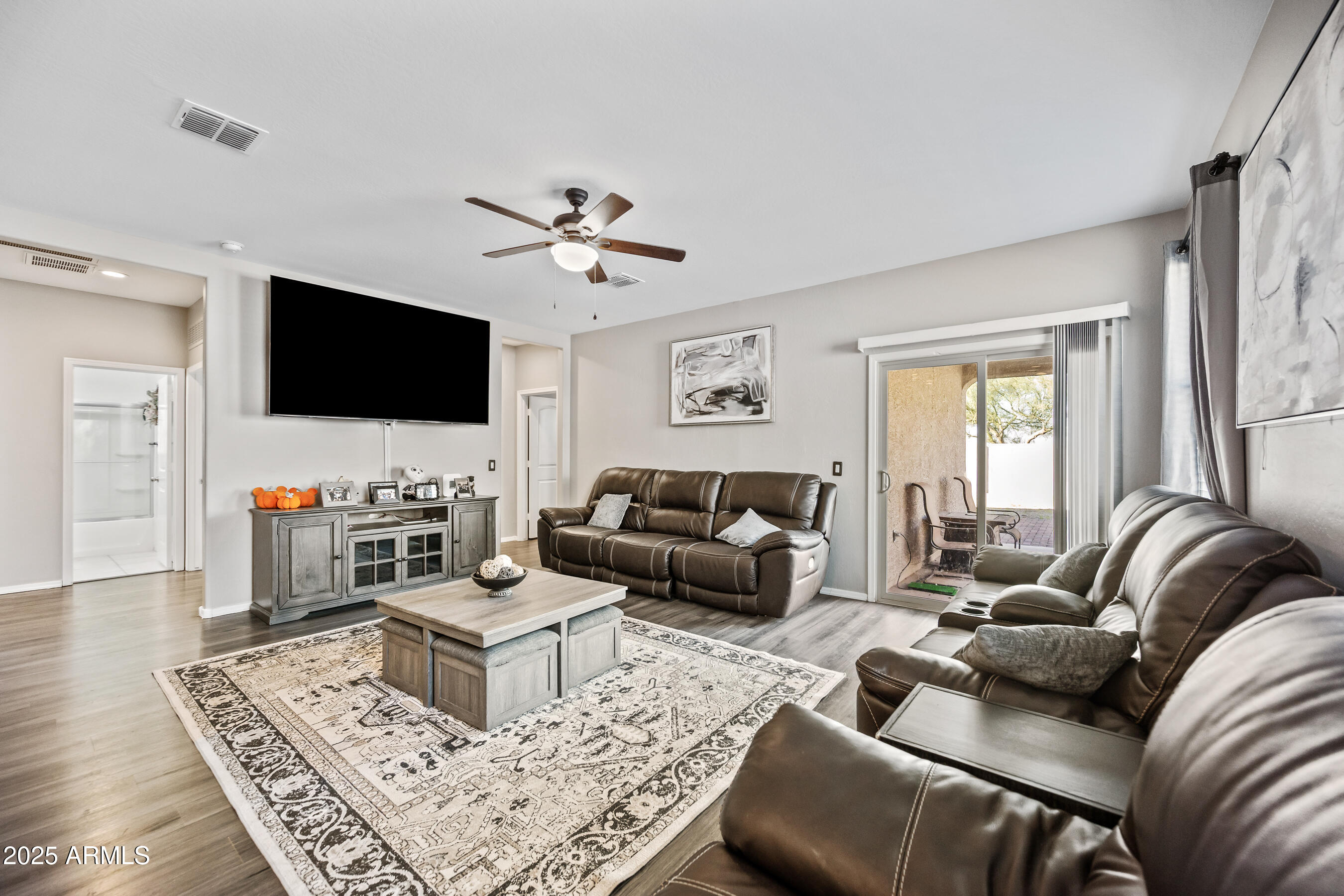 25626 West Coles Road Buckeye, AZ 85326 - Photo 6 of 31 a living room with furniture and a flat screen tv