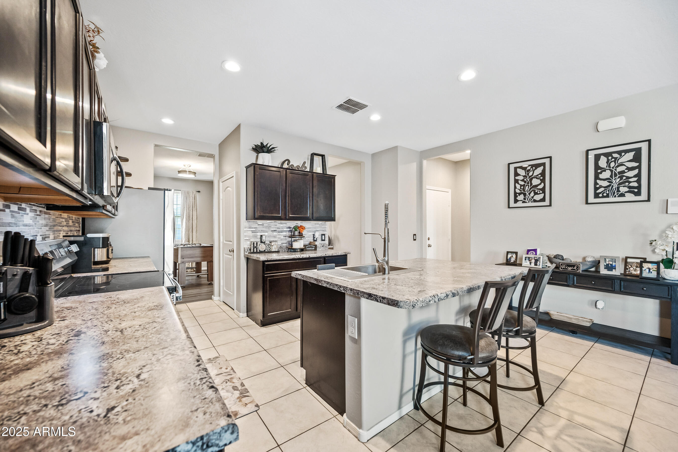 25626 West Coles Road Buckeye, AZ 85326 - Photo 9 of 31 a view of kitchen with sink microwave and cabinets