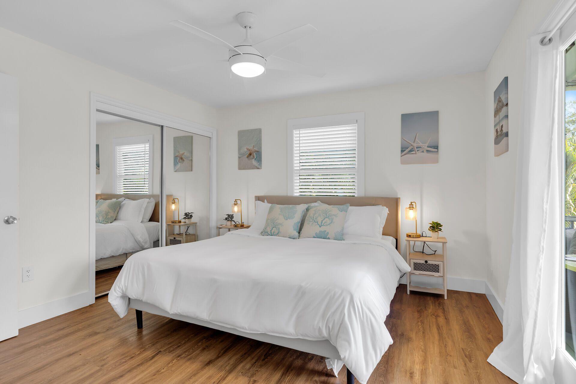 878 La Paloma Road Key Largo, FL 33037 - Photo 15 of 38 a bedroom with a bed and wooden floor