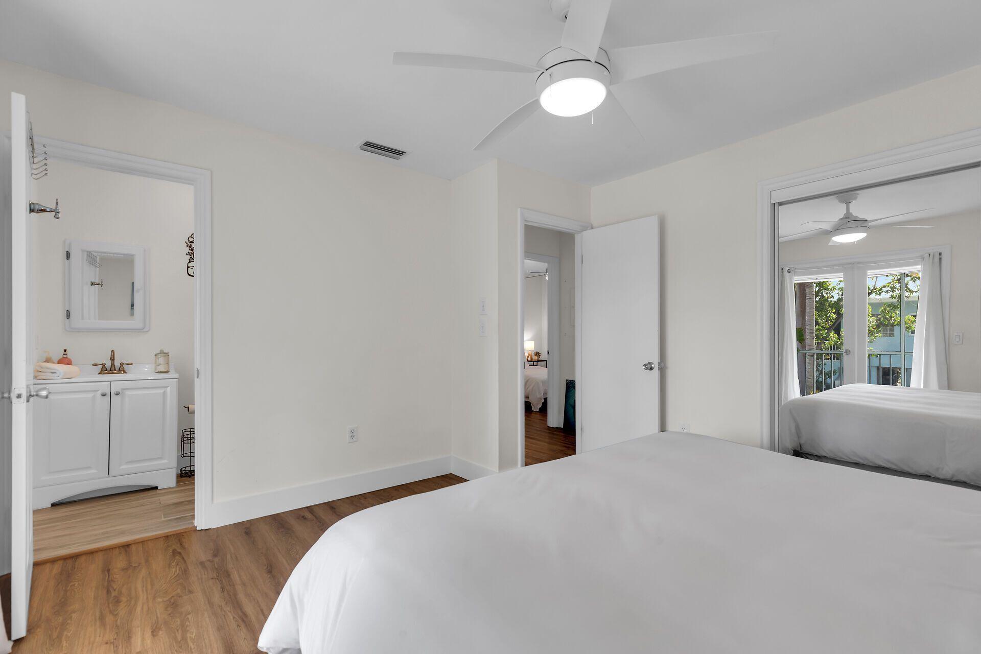 878 La Paloma Road Key Largo, FL 33037 - Photo 17 of 38 a bedroom with a bed and a window