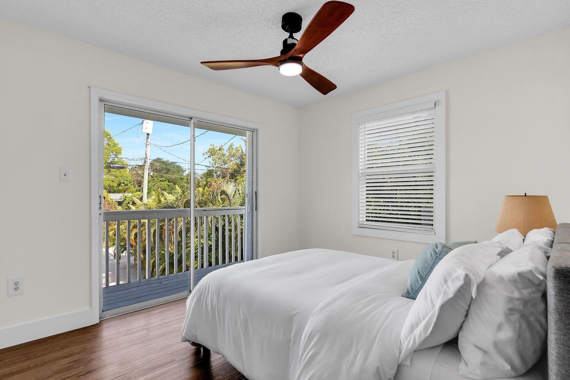 878 La Paloma Road Key Largo, FL 33037 - Photo 19 of 38 a bedroom with a bed and a large window