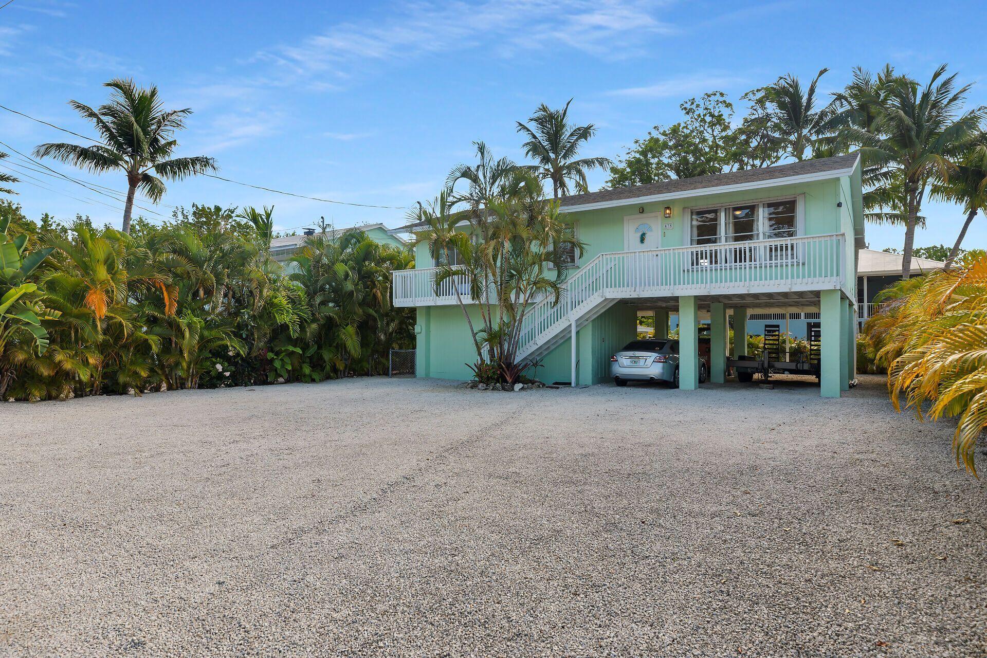 878 La Paloma Road Key Largo, FL 33037 - Photo 2 of 38 a view of a house with a street